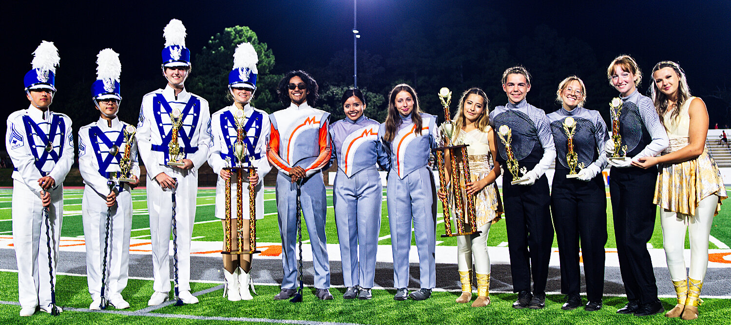 Leaders from the Lindale (left) and North Lamar (right) high school marching bands accepted awards on behalf of their ensembles Monday night at the 7th annual Mineola Marching Festival for best in the military and open categories, respectively. [note: more images here]